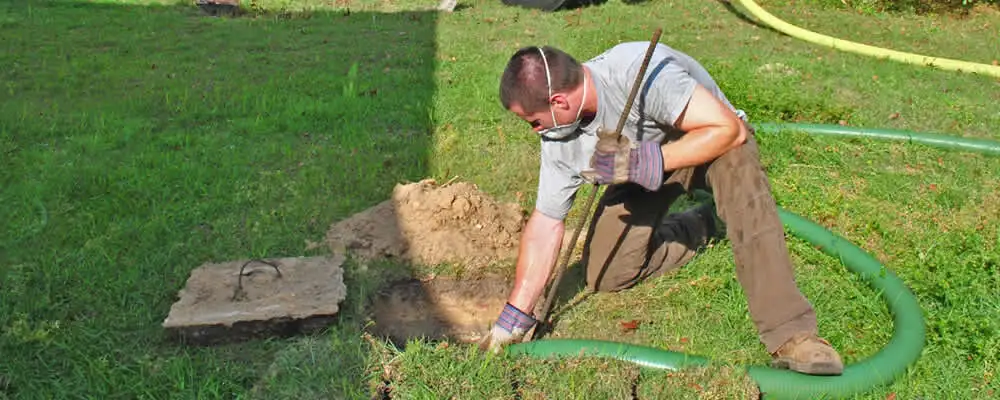 Septic pumping technician servicing a residential septic tank in Hartford, CT